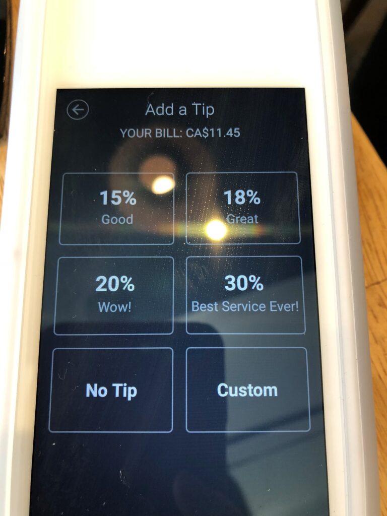 card readers displaying tip choices on screens