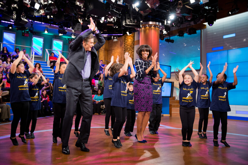 On February 22, 2013, First Lady Michelle Obama and Dr. Mehmet Oz joined students from Terence C. Reilly School No. 7 to learn a dance routine during a taping of The Dr. Oz Show at 30 Rock Studios in New York.
