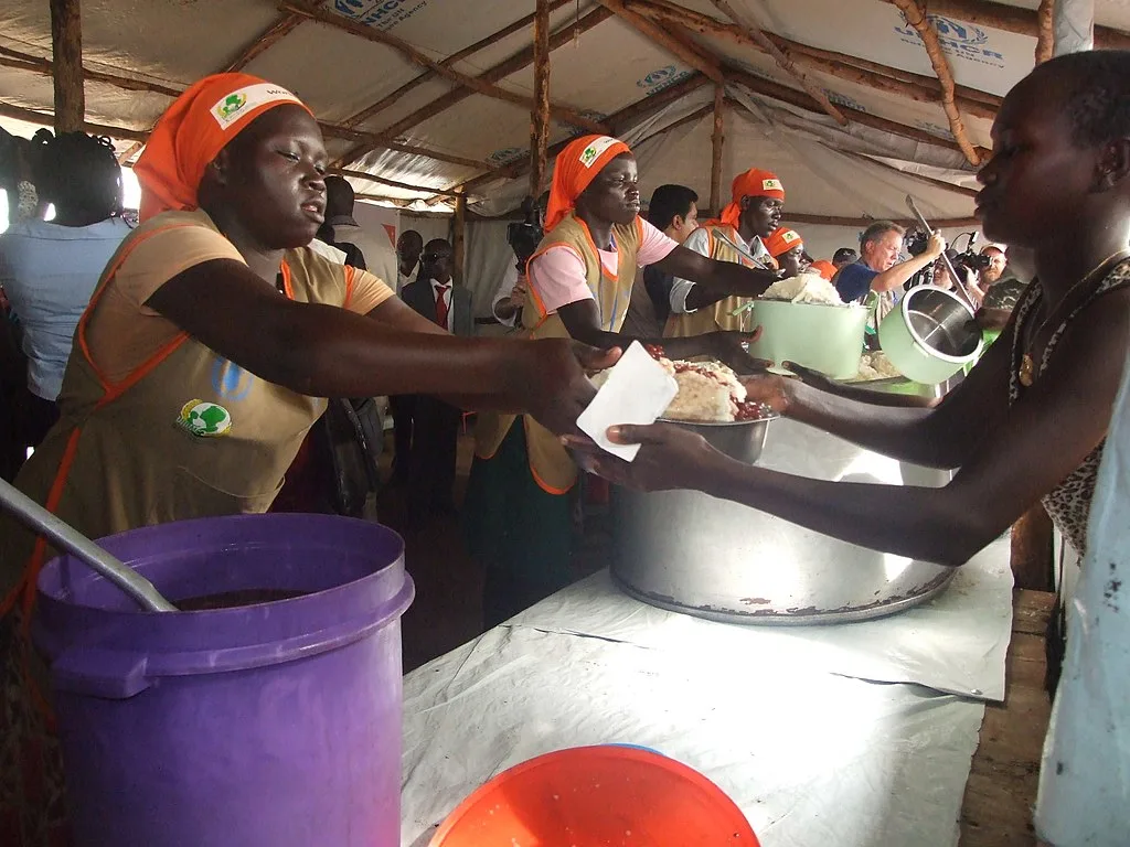 People in a Ugandan camp struggle to get a share of food in this 2007 image capturing daily life during crisis.