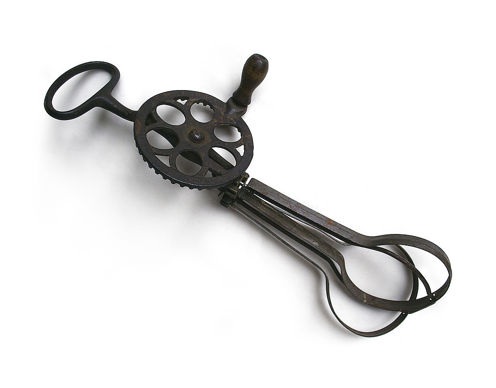 A vintage hand‑cranked mixer, preserved as a glimpse into early kitchen tools and home craftsmanship.