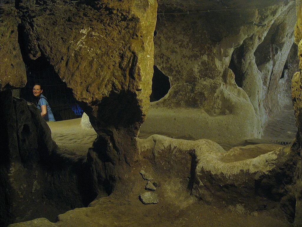 Inside the Derinkuyu underground city in Cappadocia, carved into soft volcanic rock and expanded over centuries to shelter thousands of people.