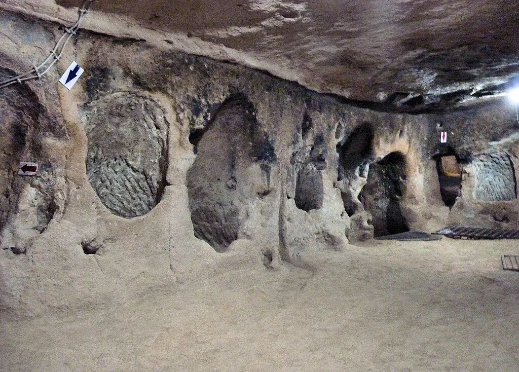 A passage inside the Derinkuyu underground city in Cappadocia, Turkey, shows the carved stone walls that once sheltered thousands of people.