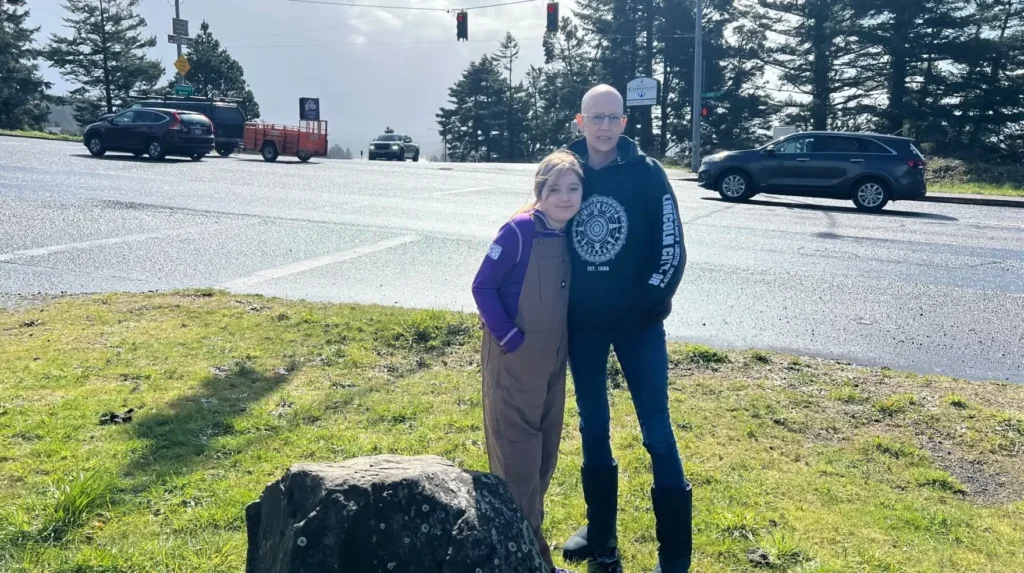 Angela Dodds with granddaughter Peyton at Highway 20 and Moore Drive in Newport, Oregon, the last known location of missing teen Kelly Lynn Disney on March 9, 1984.