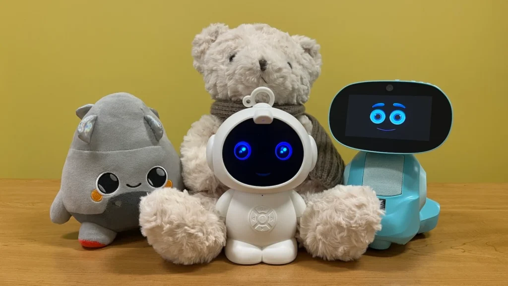 AI toys tested by U.S. PIRG including FoloToy Kumma teddy bear, Curio Grok, Robot MINI, and Miko 3 displayed together