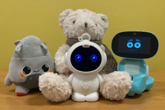 AI toys tested by U.S. PIRG including FoloToy Kumma teddy bear, Curio Grok, Robot MINI, and Miko 3 displayed together