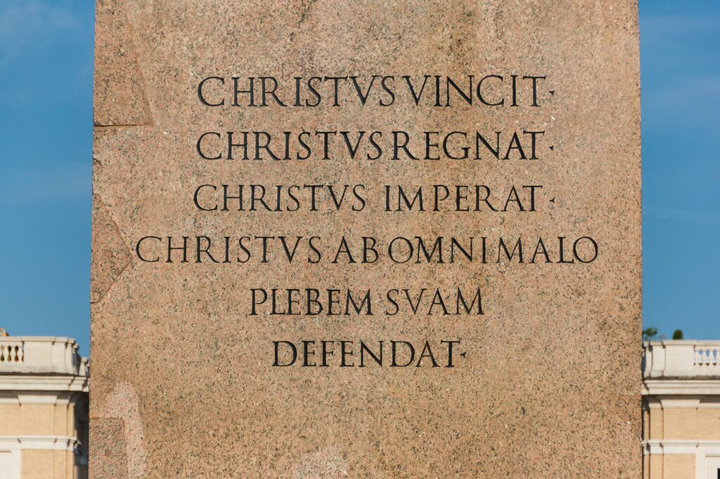 Inscription on the pedestal of the Vatican Obelisk in St Peter’s Square showing the Christian dedicatory text added after its re erection under Sixtus V