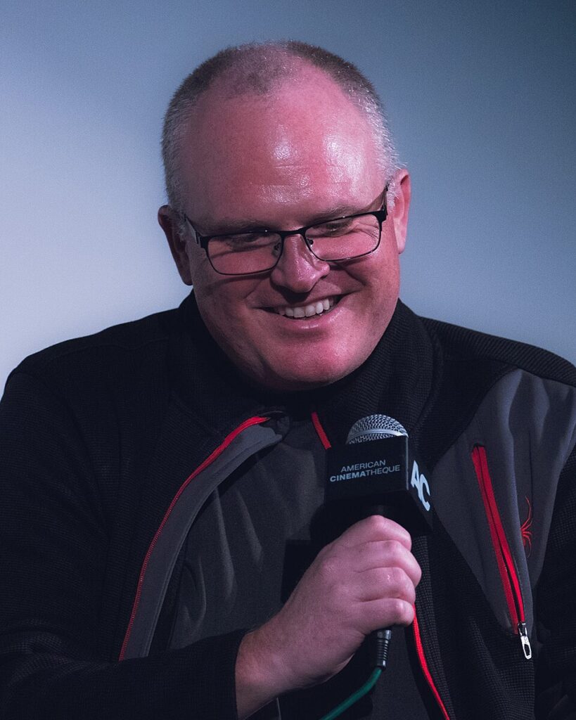 Derek Kolstad at the Wick Is Pain world premiere in Santa Monica in 2025, used in an article about how John Wick got made