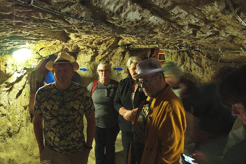 Explorers standing inside the carved tunnels of Derinkuyu underground city in Turkey