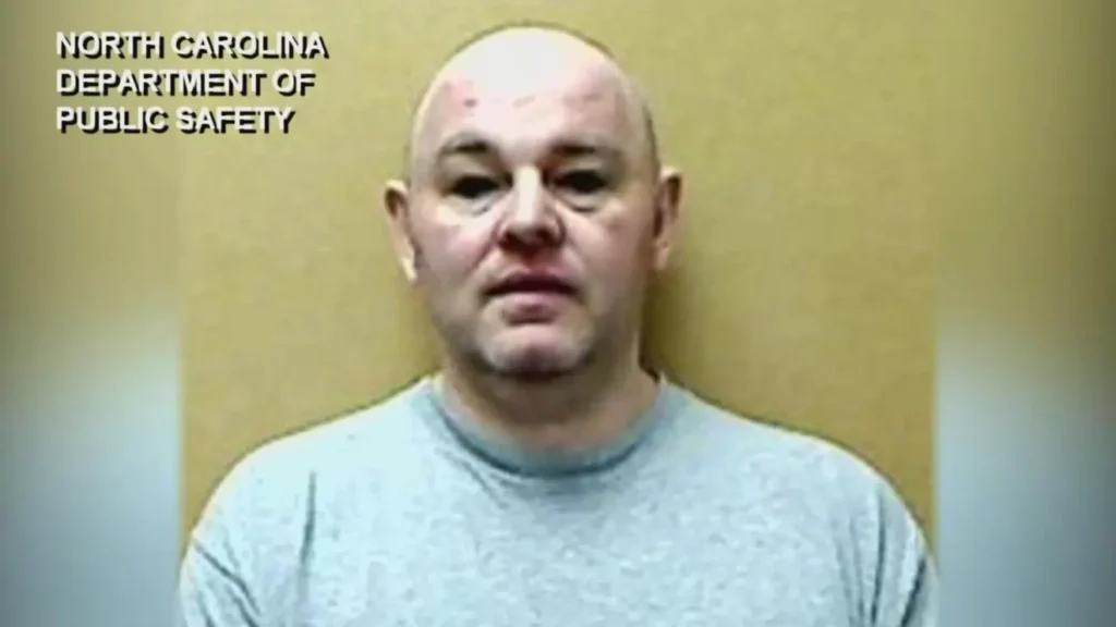Robert Jason Owens ' mug shot from The North Carolina Department of Public Safety. He is against a yellow background and not smiling.