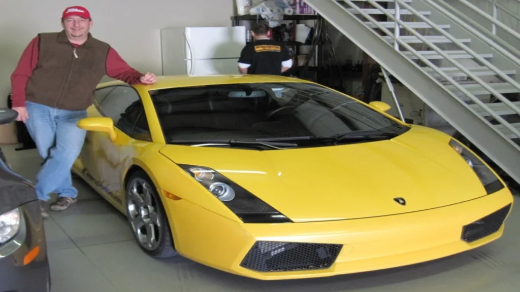 Christopher John Foster alongside his lamborghini gallardo
