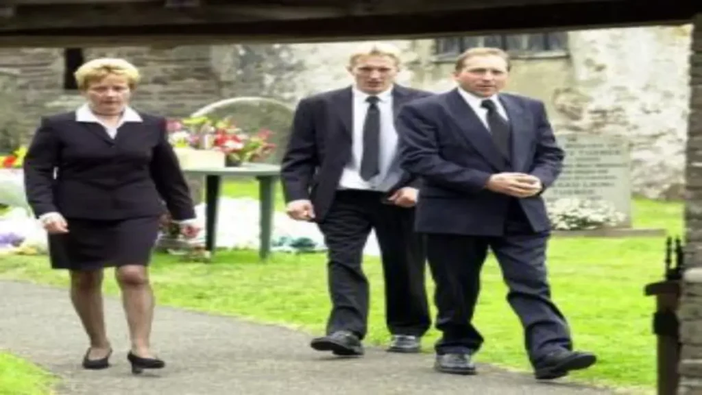 Parents Glyn and Sue and brother Gareth (background) of murdered Kirsty Jones leave her funeral