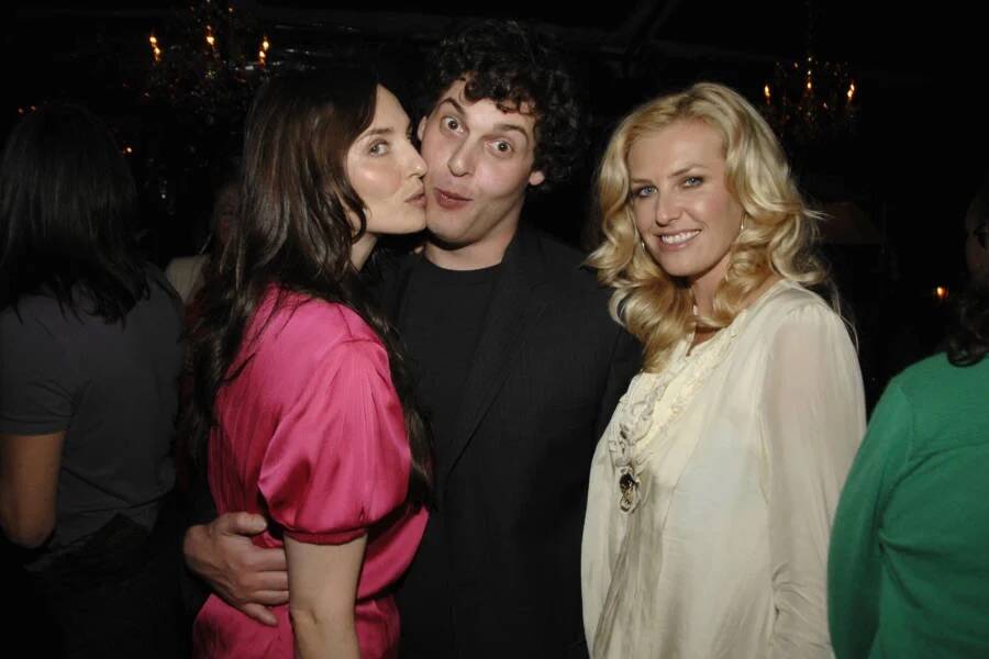 Amanda Braun, Blake Leibel, and Gina Clarke pose together at Nicolas Berggruen’s Annual Party at Chateau Marmont in Los Angeles on February 20, 2008. Braun wears a bright pink dress and leans toward Leibel, who stands between her and Clarke, while Clarke smiles at the camera in a white blouse.