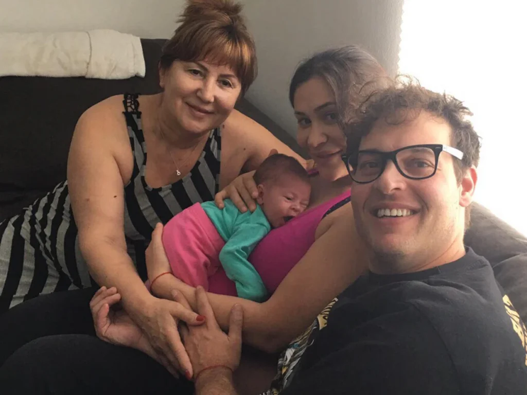 Olga Kasian sits beside her daughter Iana Kasian, who is holding newborn Diana, while Blake Leibel smiles for a selfie on a couch in Los Angeles, shortly before Iana Kasian’s 2016 murder.
