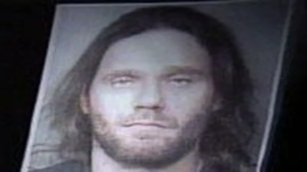 Archival photograph of Christopher J. Below with long dark hair and a light beard.