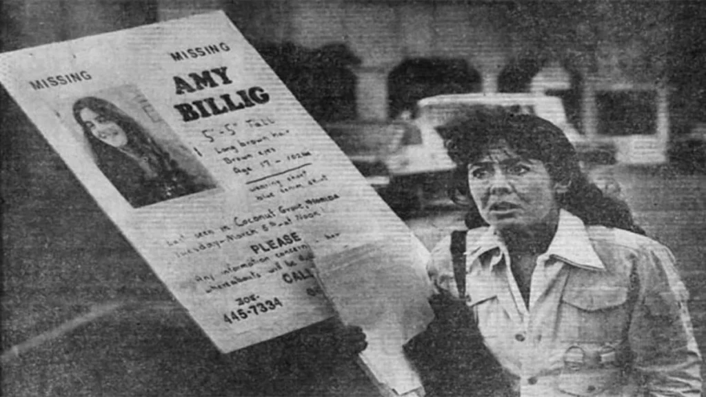 Susan Billig standing beside a missing-person placard for her daughter Amy in March 1974.