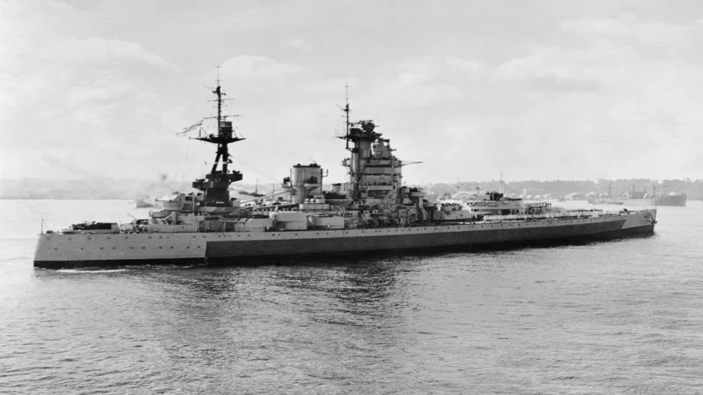 HMS Nelson at sea during the Second World War, with Royal Navy crew visible on deck.