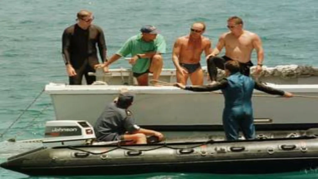 Australian police and naval search teams aboard a small inflatable boat beside a larger vessel during the search for Tom and Eileen Lonergan.