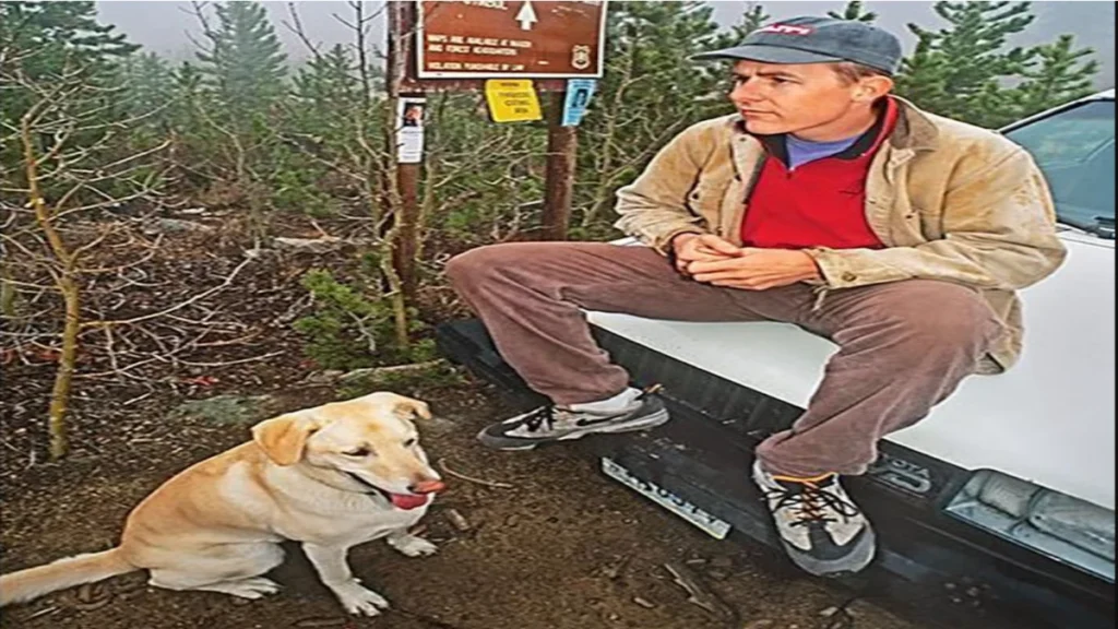 Steve Bechtel and his dog, Jonz, sitting on the hood of the white Toyota Tercel