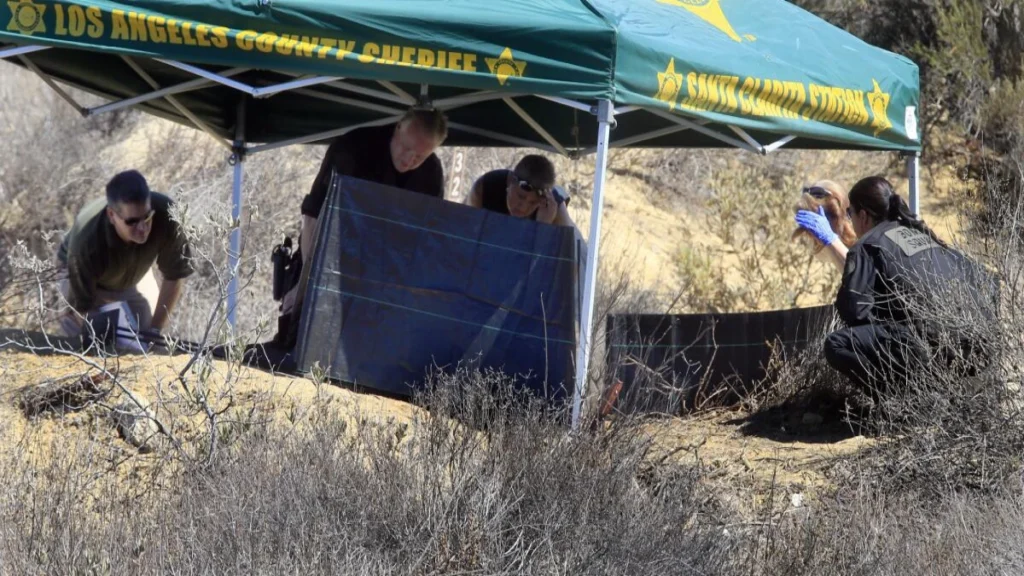 Investigators near Castaic Lake after burned remains were found close to the area where Bryce Laspisa disappeared.