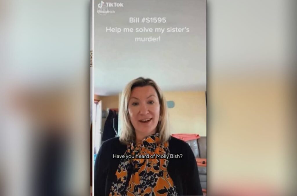 Screenshot of Heather Bish on TikTok holding a photo of her sister Molly Bish while asking viewers to help share information about Molly’s unsolved murder case.