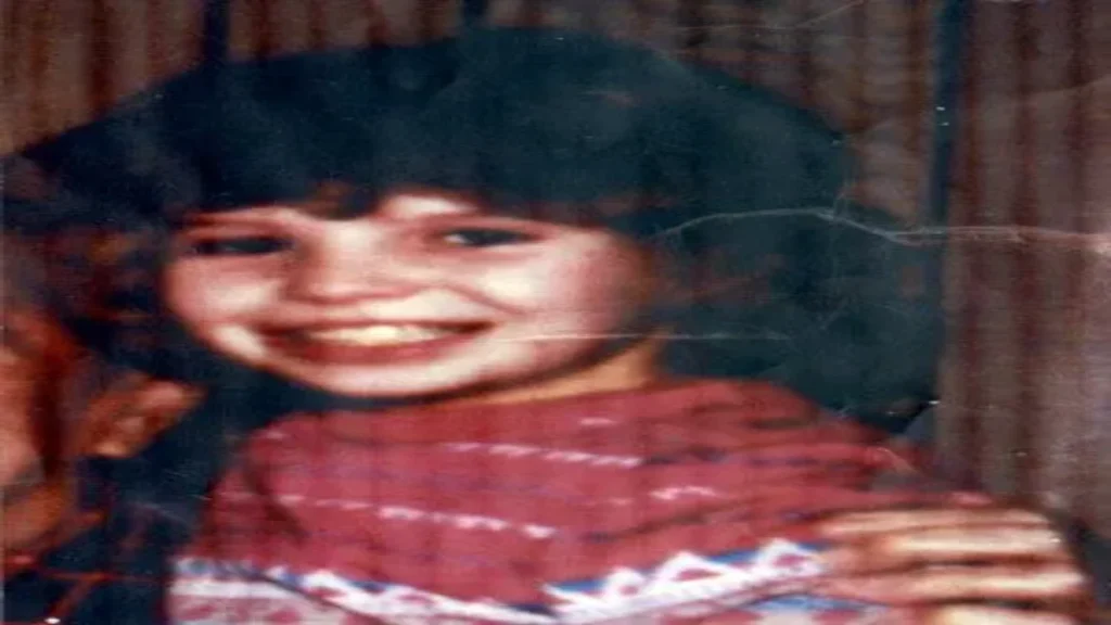 Close-up family photograph of Jo-Anne Pedersen smiling, with shoulder-length dark hair and bangs.

