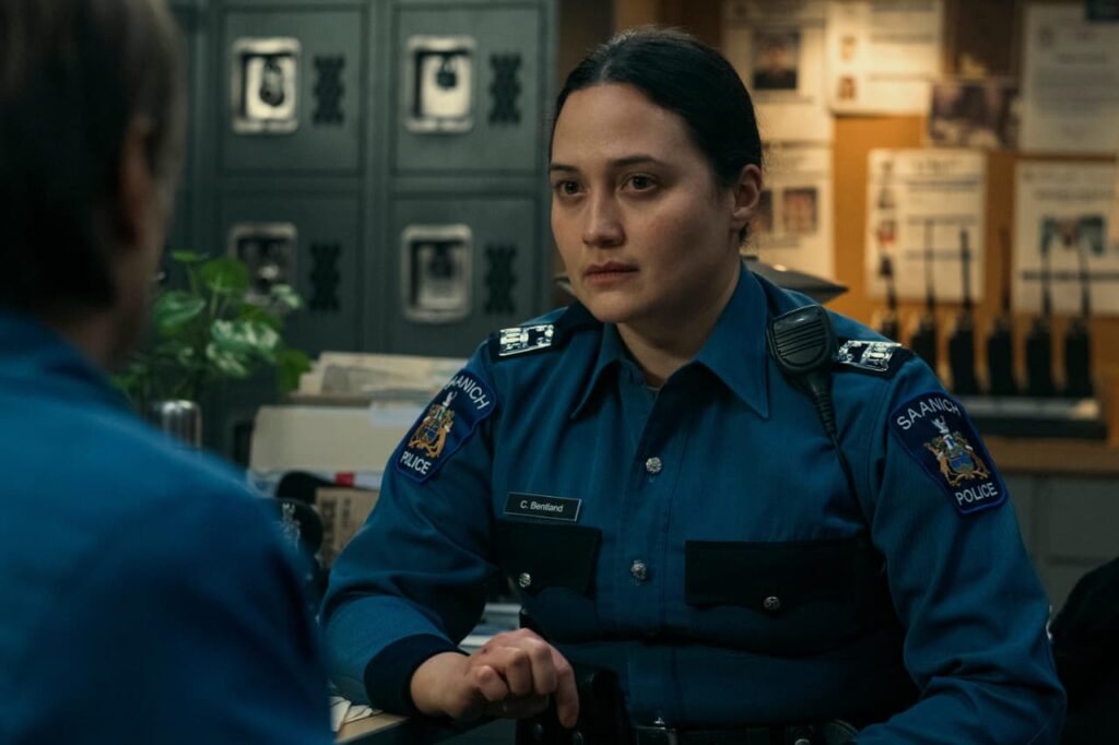Cam Bentland, an Indigenous police officer played by Lily Gladstone, created as a composite character combining multiple real-life figures from the Saanich Police Department, responsible for investigating Reena's death. Image taken from the ABC and HULU mini series 'Under the Bridge'.