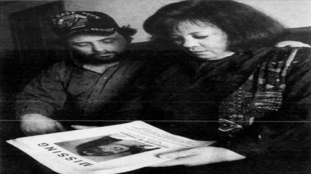 Darlene Farrell and Duane Childers holding a missing-person poster featuring Shaylene Farrell.