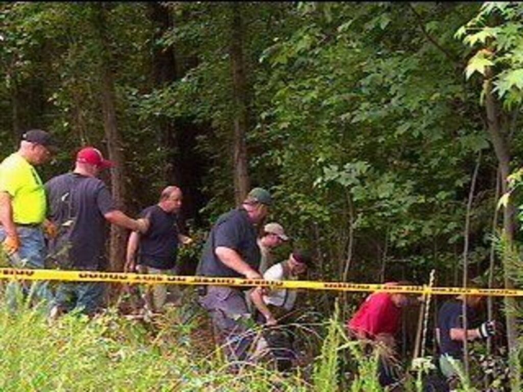 GBI investigators and volunteer firefighters searching woods near Interstate 185 after human remains were found.