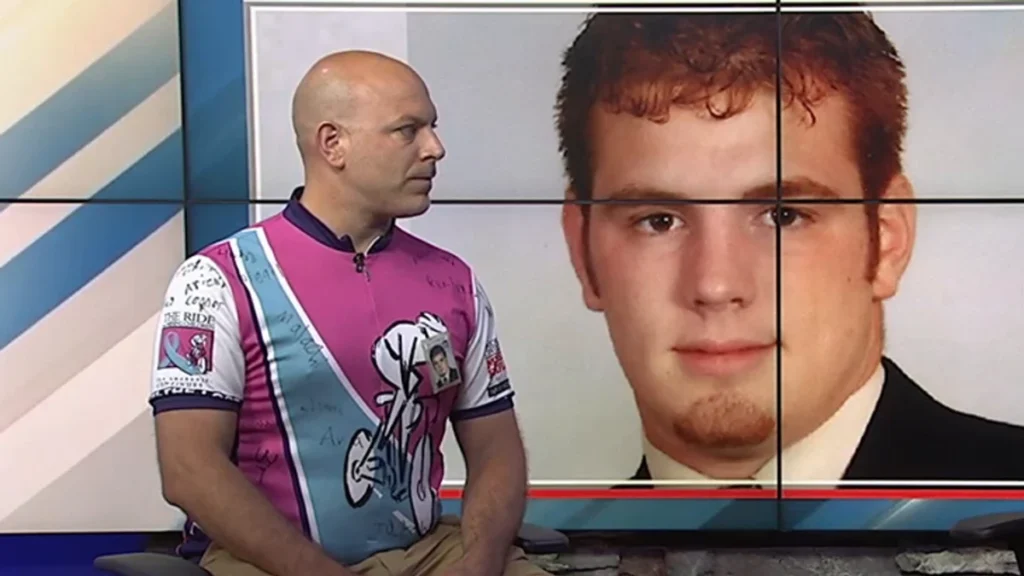 Matthew Frear wearing a Ride for Missing Children jersey during a CBS 6 Albany television interview.