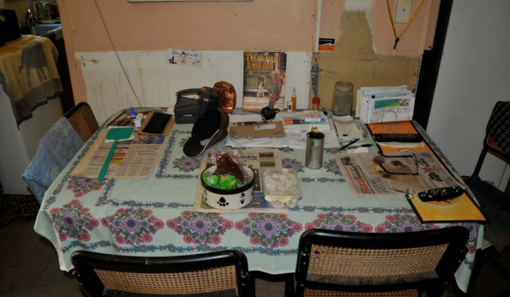 Paddy Moriarty’s kitchen table photographed days after his disappearance, with food, newspapers, personal items and household objects left undisturbed.