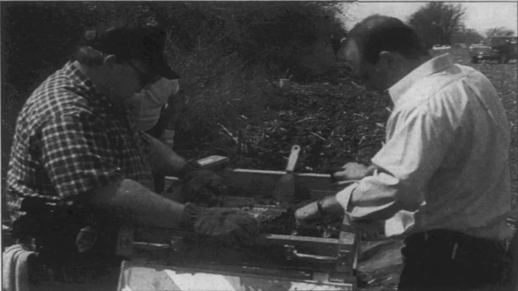 Piqua police investigators Tom Higgins and Mark Whitaker examining dirt collected during a search for Shaylene Farrell.
