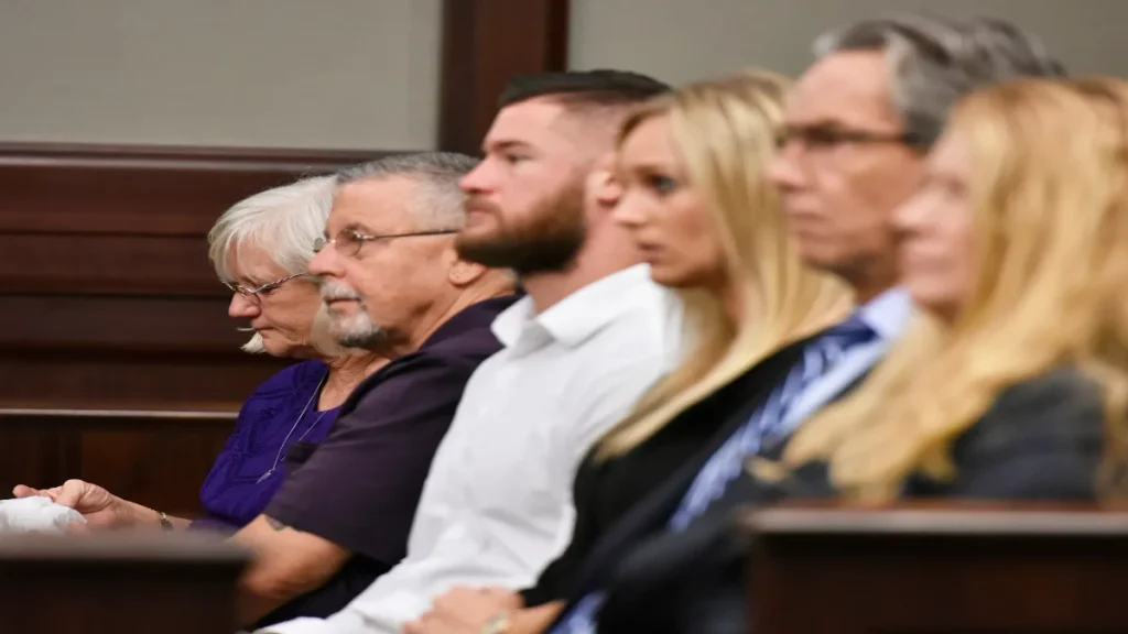Sheila Clifton DeLongis seated with family members during Joshua Phillips’s resentencing hearing.
