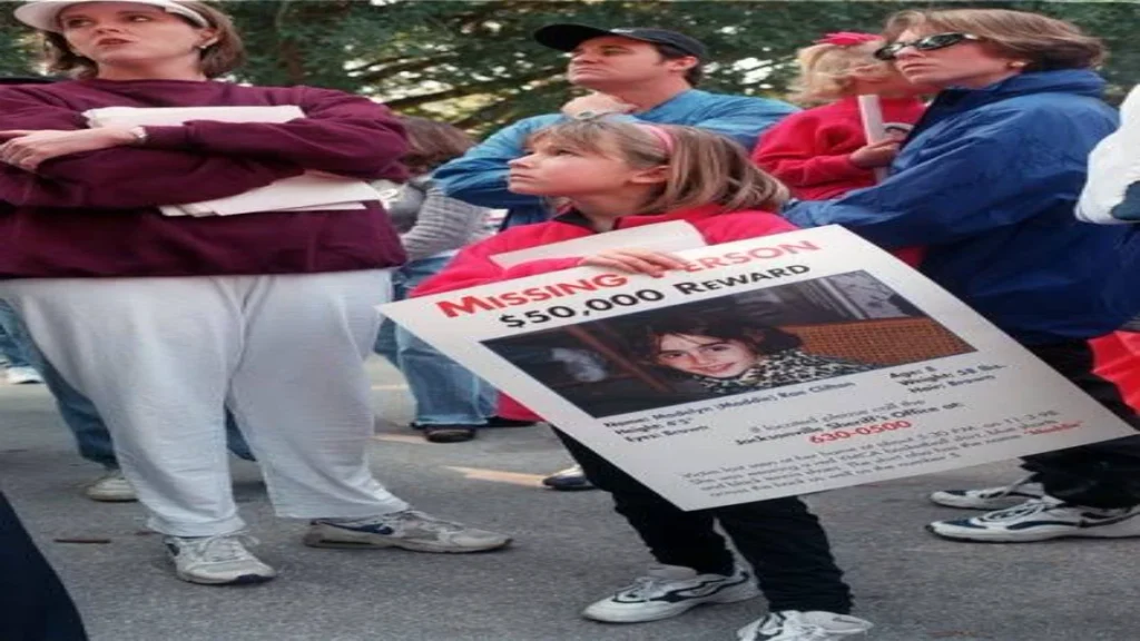 Seven-year-old Karson Cobb holding a missing-person poster for Maddie Clifton during the search.