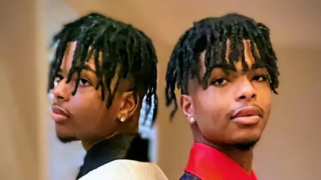 Identical twins Qaadir and Naazir Lewis posing back-to-back.