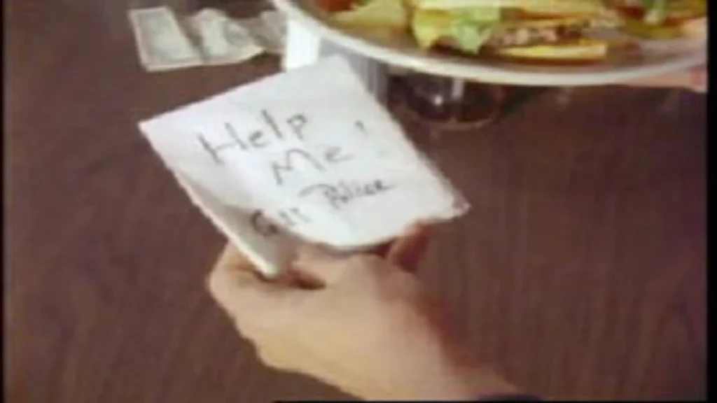 A television reenactment displaying the desperate "Help Me! Call Police" note left under a plate by a young girl matching Anthonette Cayedito's description at a restaurant in Carson City, Nevada.