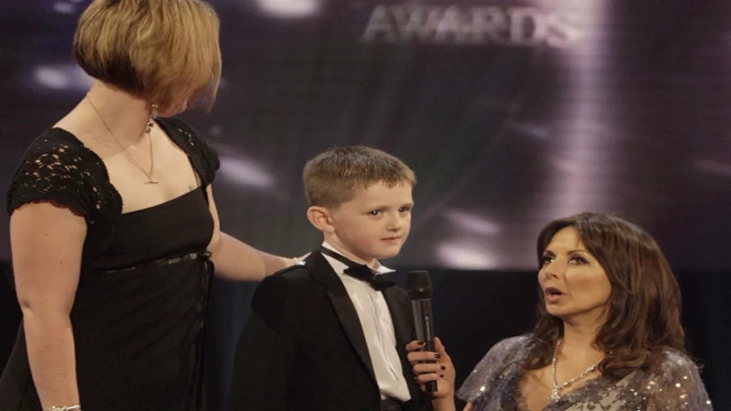 An emotional moment on stage at the Pride of Britain Awards, as a young Nathan Thomson stands alongside his mother, Ena Thomson, while host Carol Vorderman holds a microphone to interview him about his incredible bravery. photo published by pride of britain