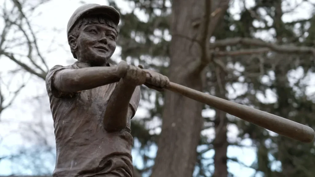 A statue of the unofficial mayor of Savona overlooks a ball field named in honor of Derrick Robie.