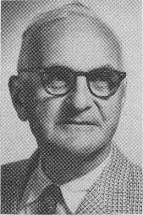 Black-and-white portrait of Donald Ewen Cameron wearing dark-rimmed glasses, a checked jacket and a tie.