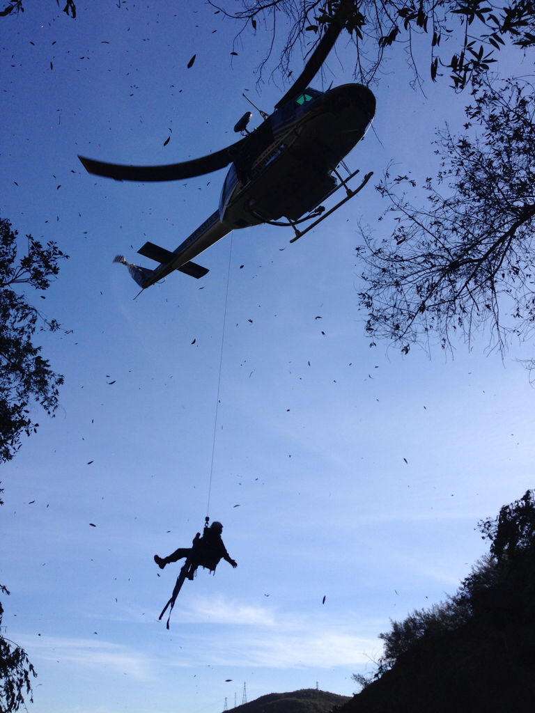 Rescue personnel are lowered by helicopter into the Tangerine Falls area during the operation to airlift Saylor Guilliams to hospital.