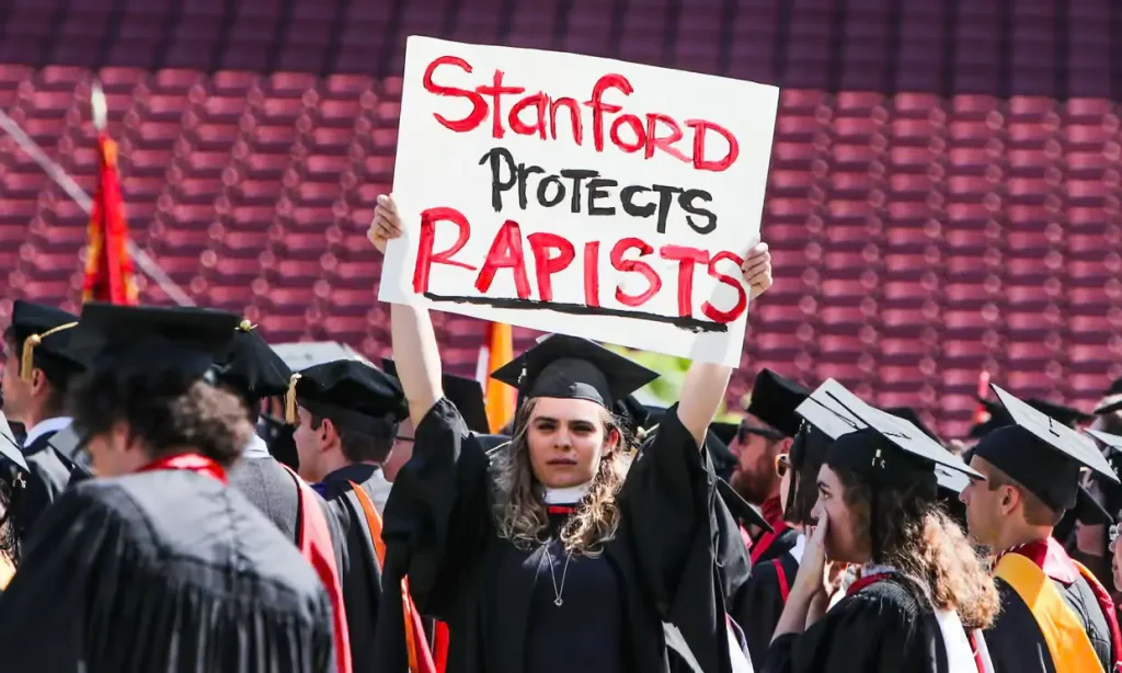 A woman carries a sign in solidarity for Miller during graduation at Stanford University. Photograph: