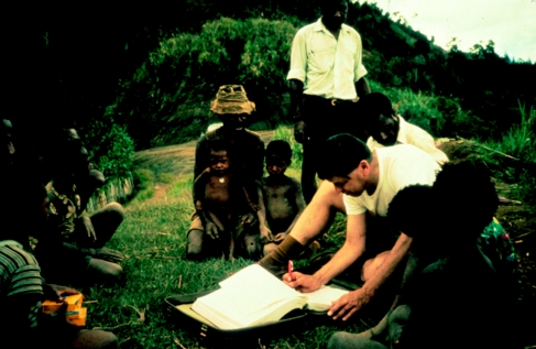 Dr. Carleton Gajdusek reviewing printed kuru research records in Awande village, Papua New Guinea, in 1972.