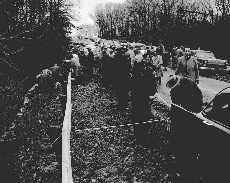 Police and onlookers gathered beside a rural Illinois road at the Grimes sisters' 1957 crime scene.