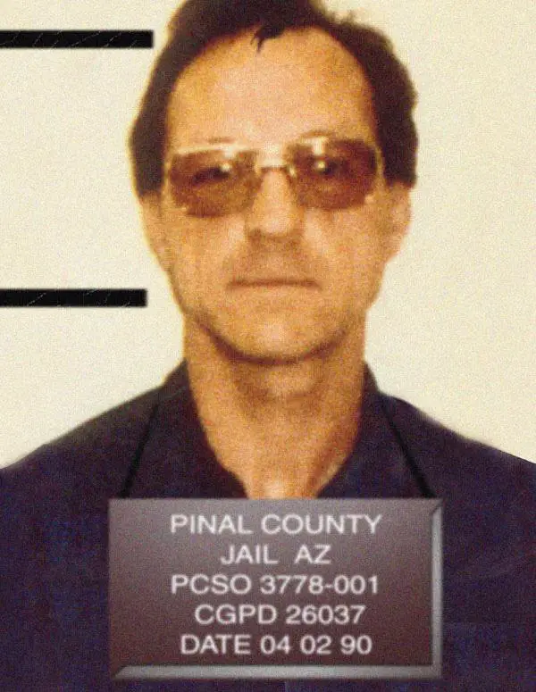 Robert Ben Rhoades wearing tinted glasses in his April 2, 1990, Pinal County Jail booking photograph.